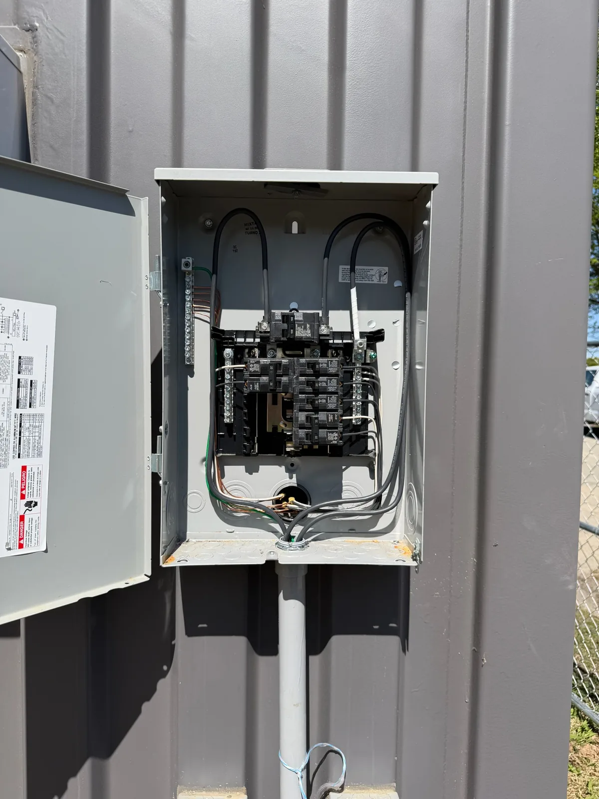 Exterior breaker panel and disconnect mounted on a metal building