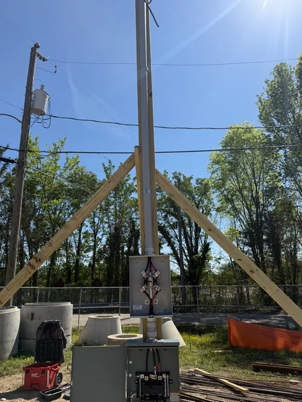 Braced temporary power pole with meter base set on a job site